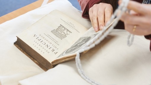 Student handling an old book